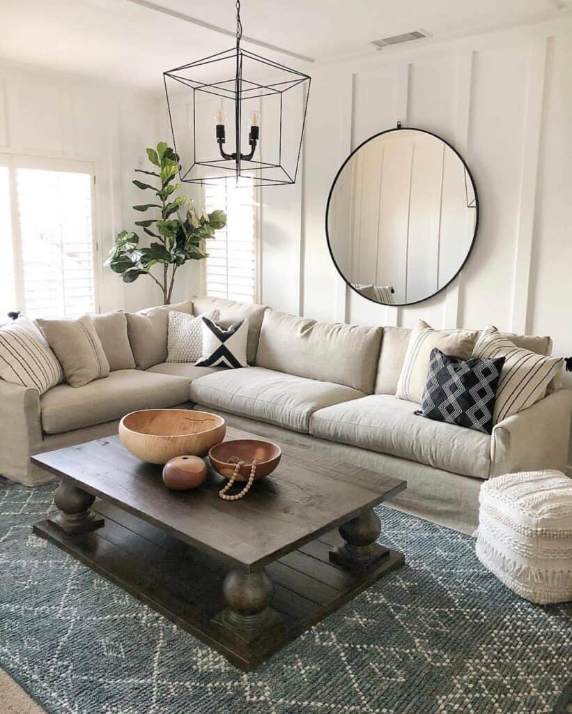 Farmhouse living room with accent board and batten wall and sectional next to rectangular wooden coffee table