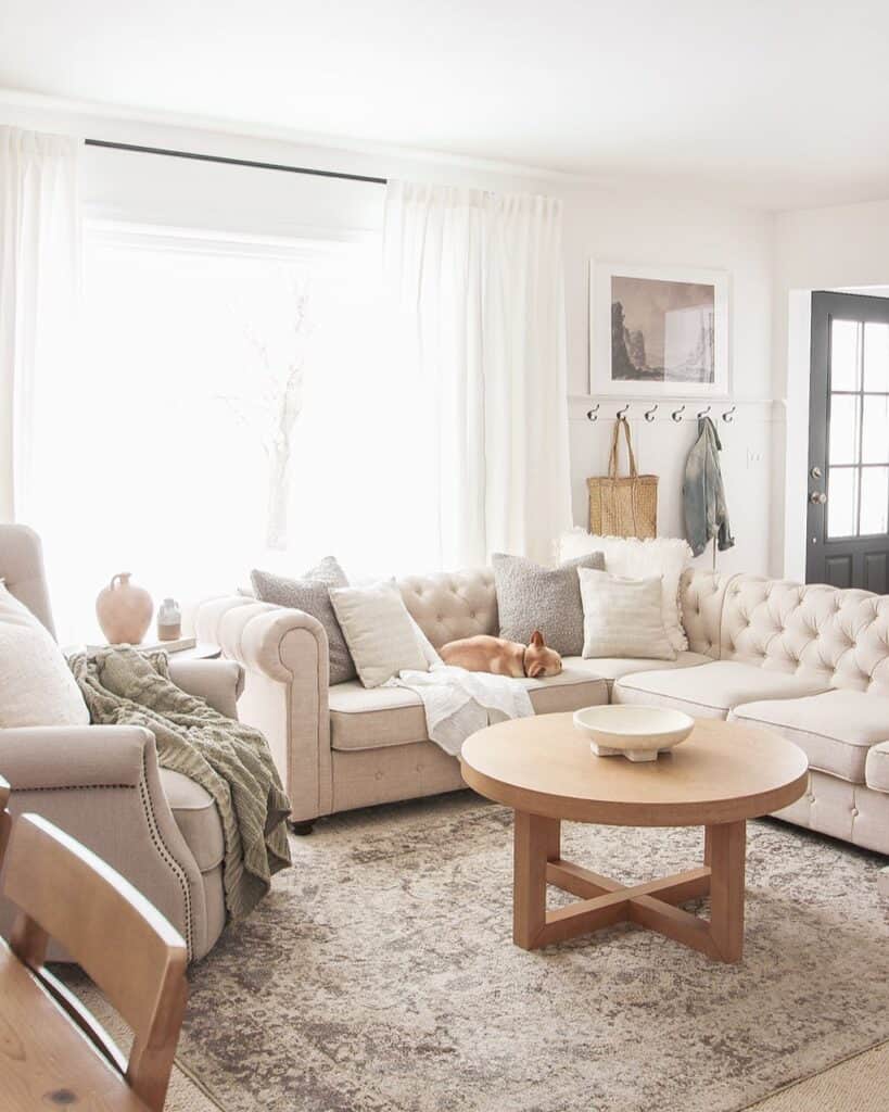 beige sectional with wood round table