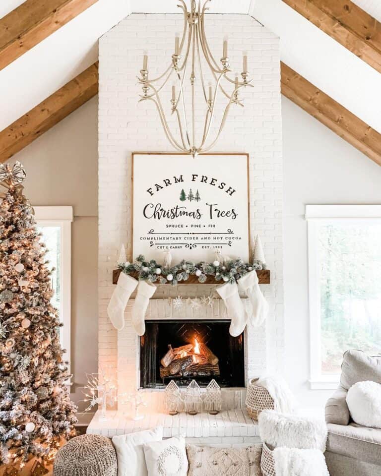 living room with floor to ceiling white brick fireplace and walls painted in Agreeable Gray by Sherwin-William