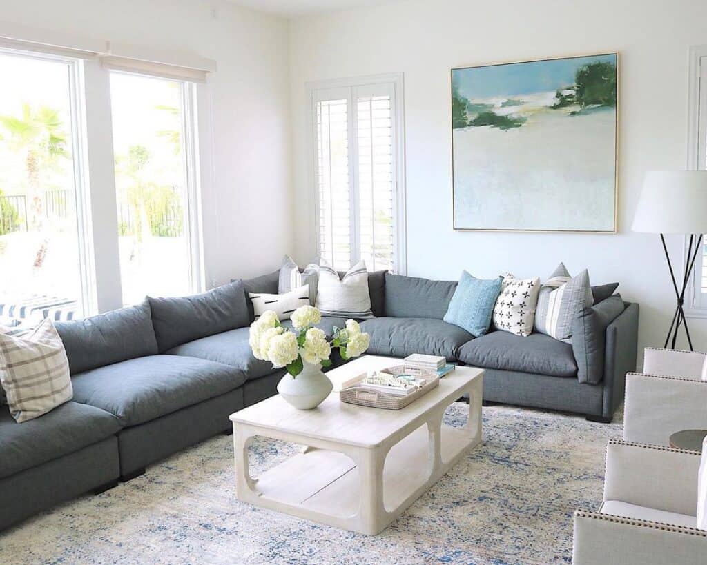 white floor shelf coffee table next to sectional couch in living room