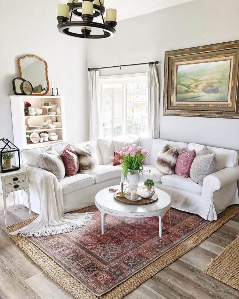 white slipcovered sectional on antique rug next to white round coffee table