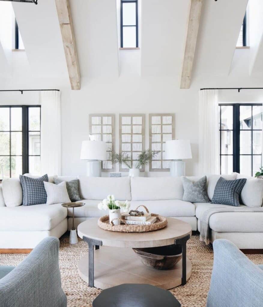 wooden round coffee table with off-white sectional sofa in living room