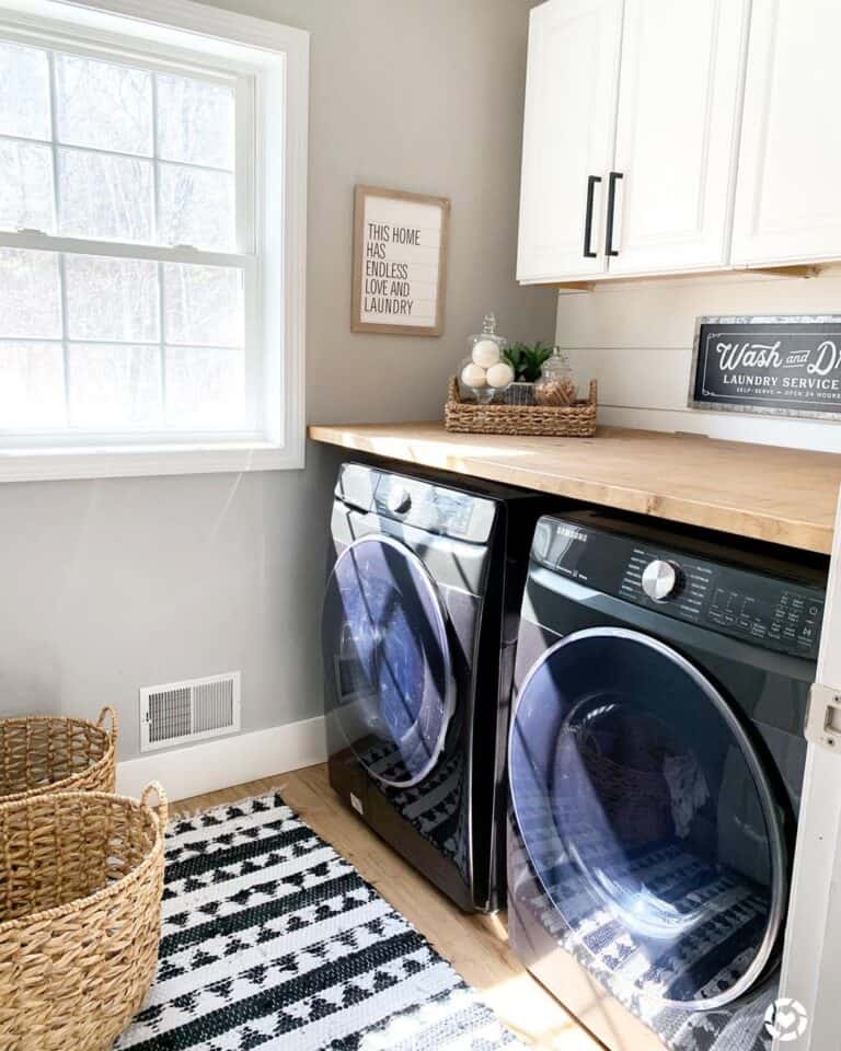 Black Washer and Dryer with Light Wood Countertop