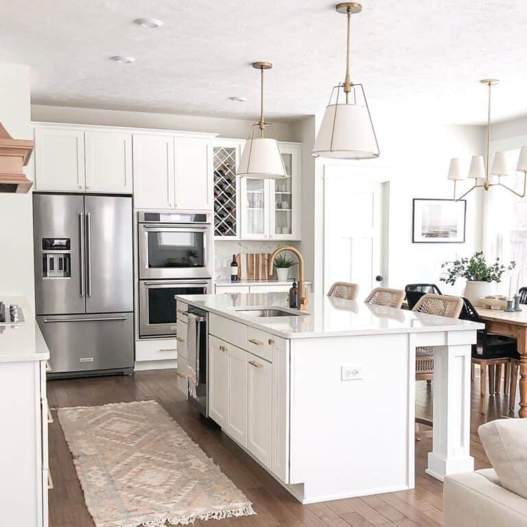 White Kitchen Island with White Countertop and brass faucet