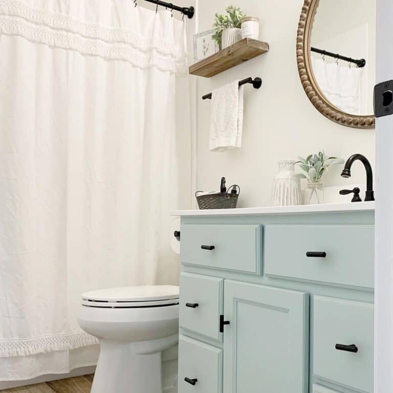 Light Blue Vanity Cabinet Next to Toilet