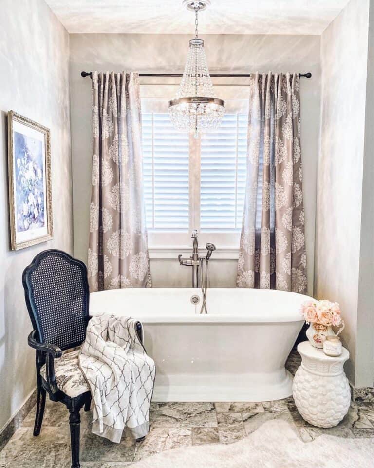 Bathtub in Front of Farmhouse Window Shutters
