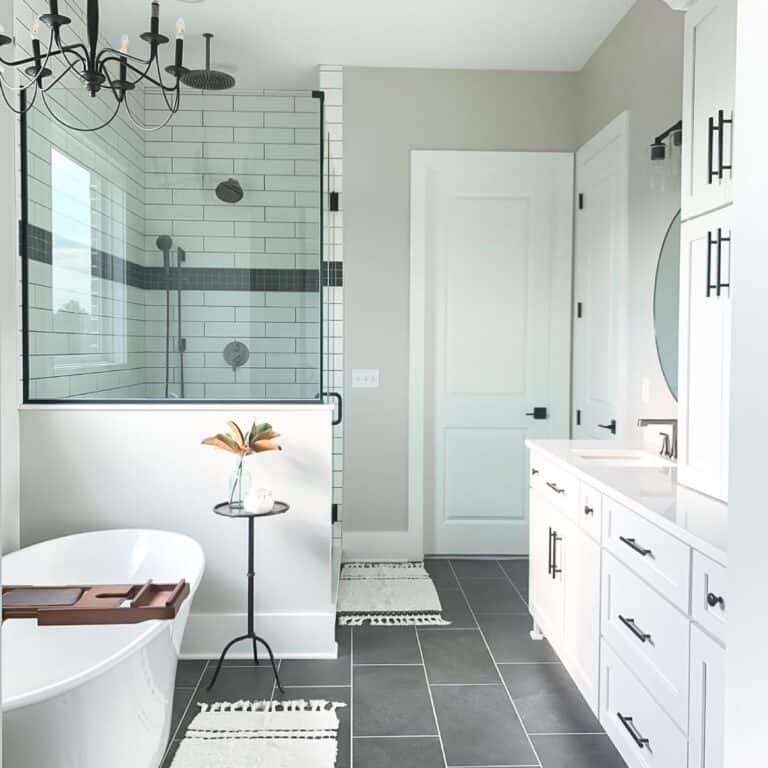 Oval Bathtub Next to Glass Half Wall Shower