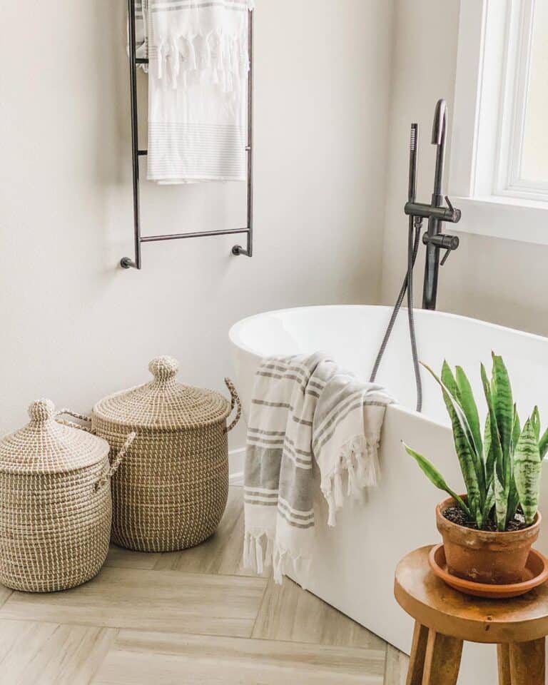 White Bathtub with Black Towel Ladder