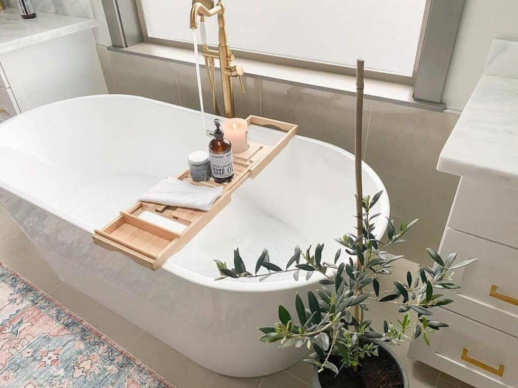 White Freestanding Tub with Brushed Gold Faucet