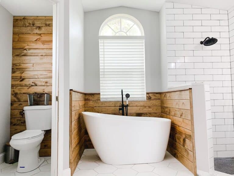 White Soaking Tub Next to Water Closet
