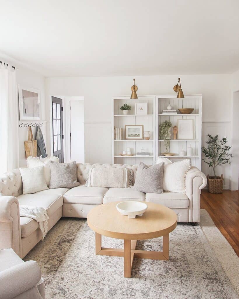 Beige Chesterfield Sectional with Round Coffee Table Soul & Lane