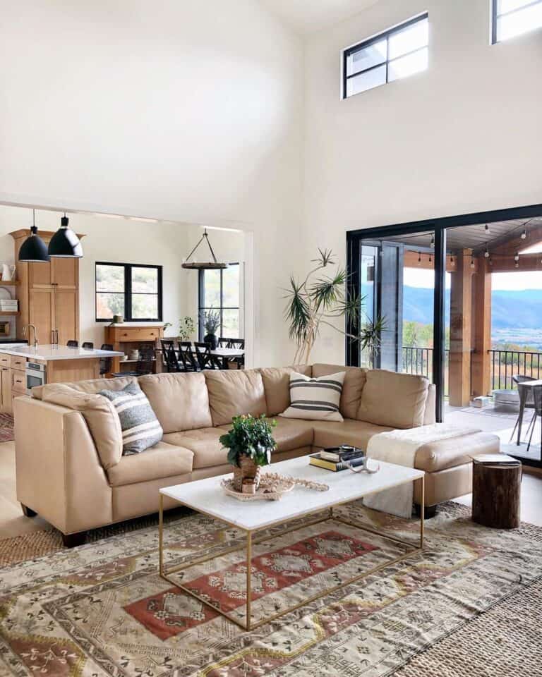 Beige Leather Couch with Gray Striped Pillows