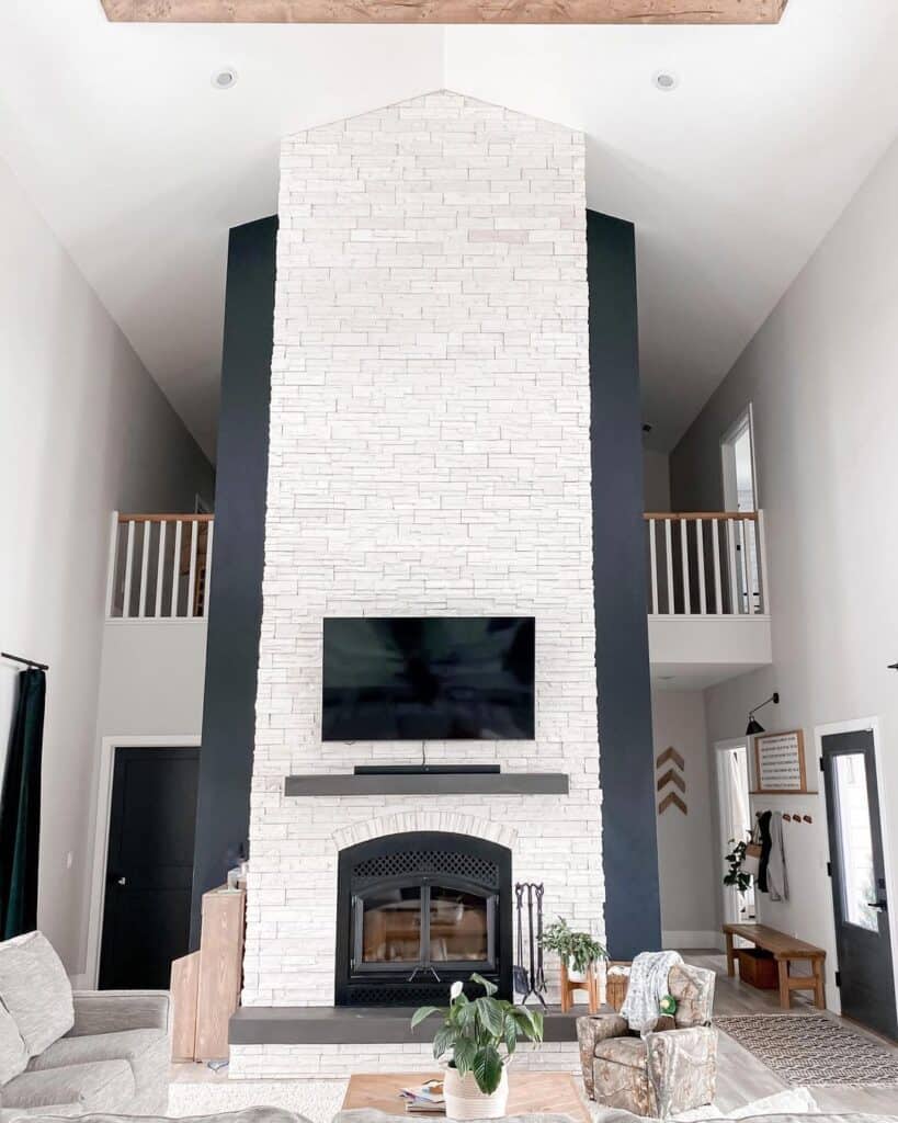 Black Living Room Wall with White Stone 2 Story Fireplace