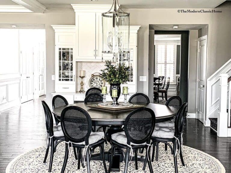 Black Dining Chairs With White Cushions on a Round Rug