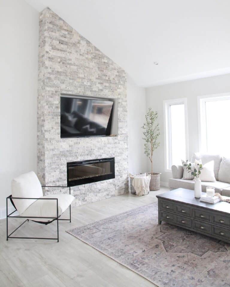 Slanted Ceiling Living Room With Brick Fireplace