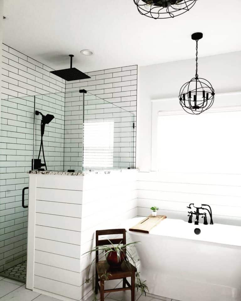 Black Shower Head Over a White Subway Tile Shower