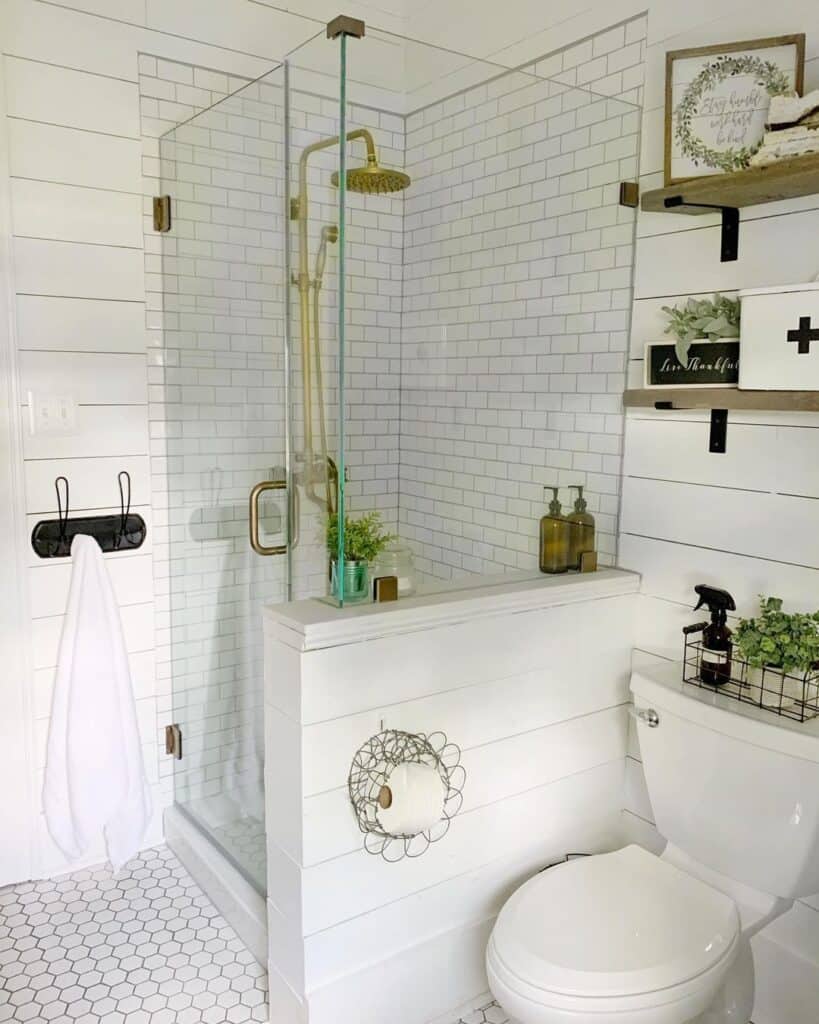 Brass Shower Head With a Hose and Subway Tile Walls