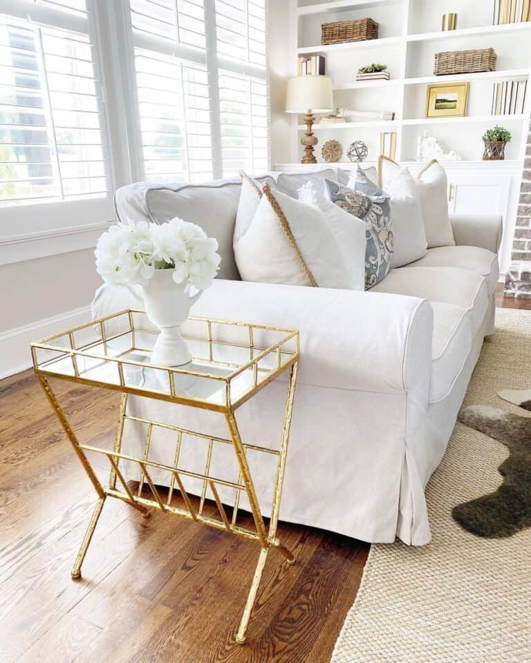 Beige Slipcovered Couch with Gold End Table