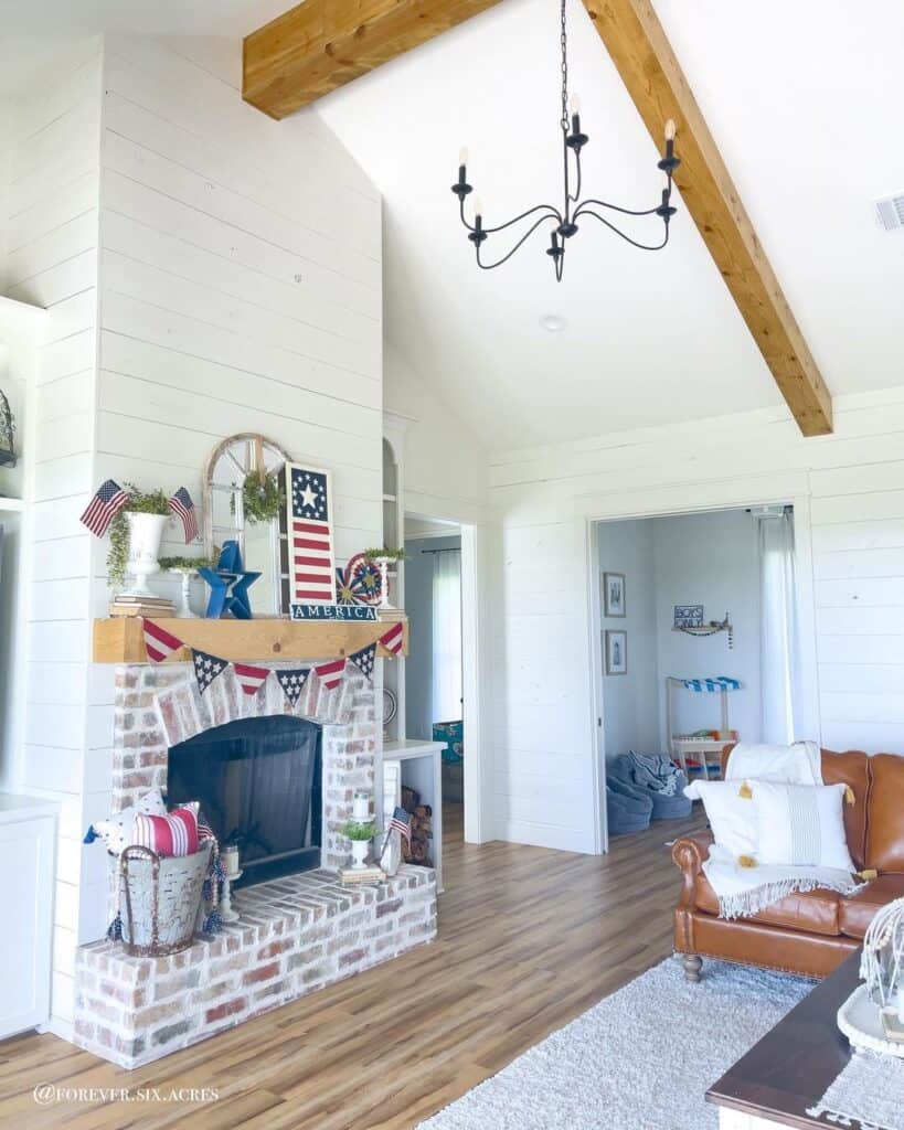 Whitewashed Brick Fireplace with Light Wood Mantel