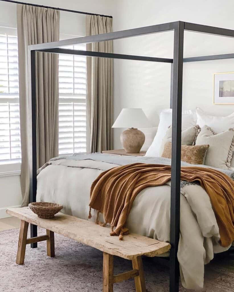 Black Canopy Bed with Rustic Wood Bench