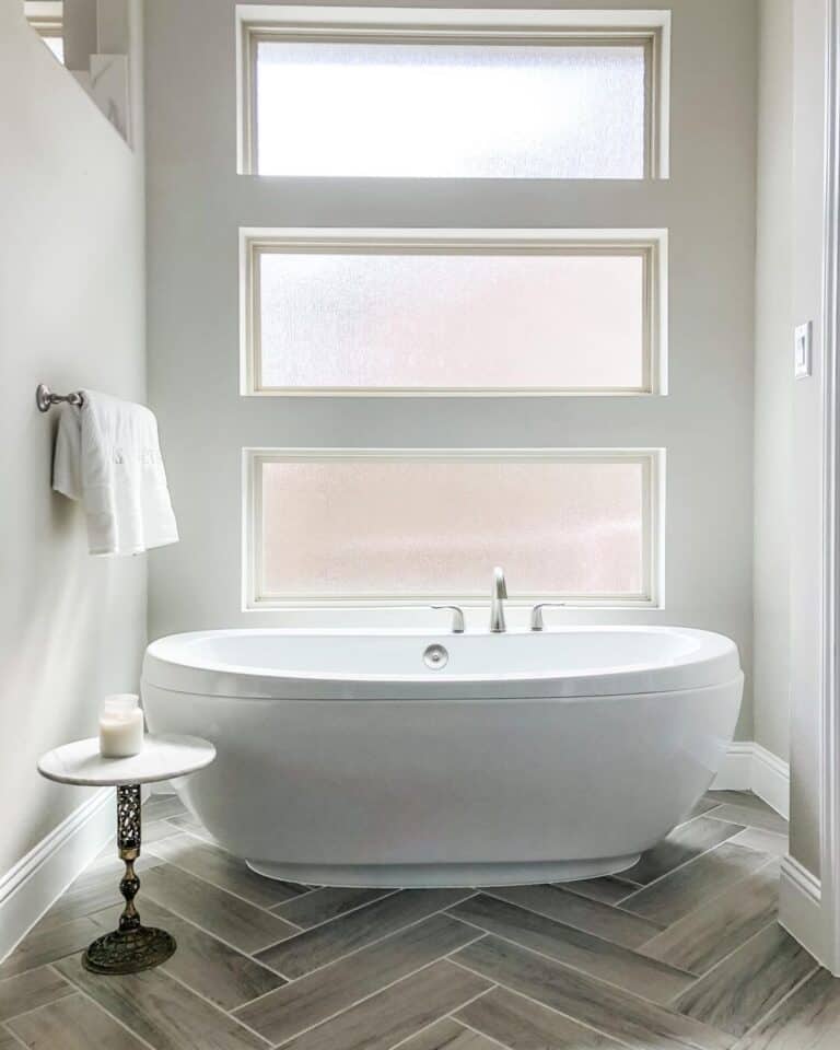 Bathtub on Stained Wood Herringbone Floors