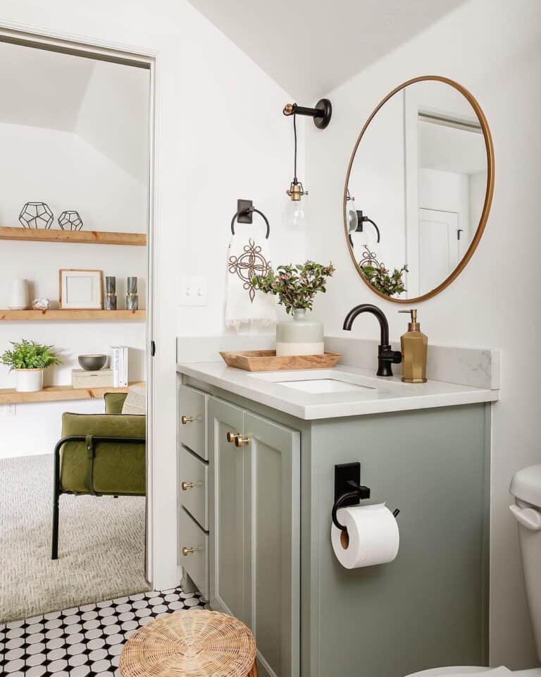 Gold Circular Mirror Above Grey Bathroom Cabinet