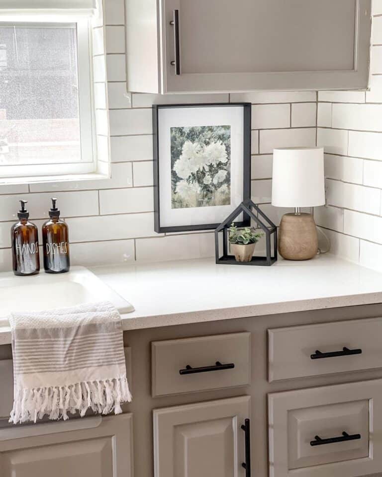 Offset White Tile Above a Grey Bathroom Cabinet