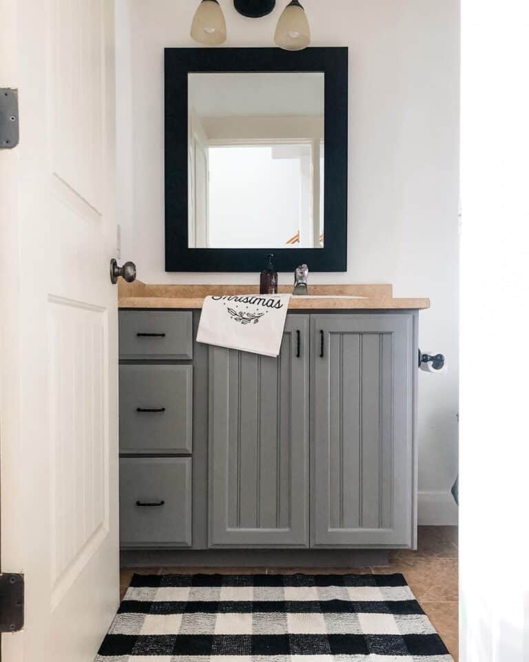 Wood Colored Countertop on a Gray Bathroom Cabinet