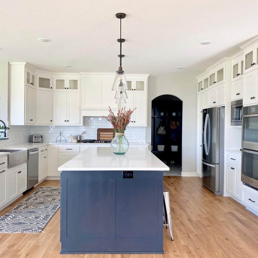 Arched Doorway Leads to White Kitchen