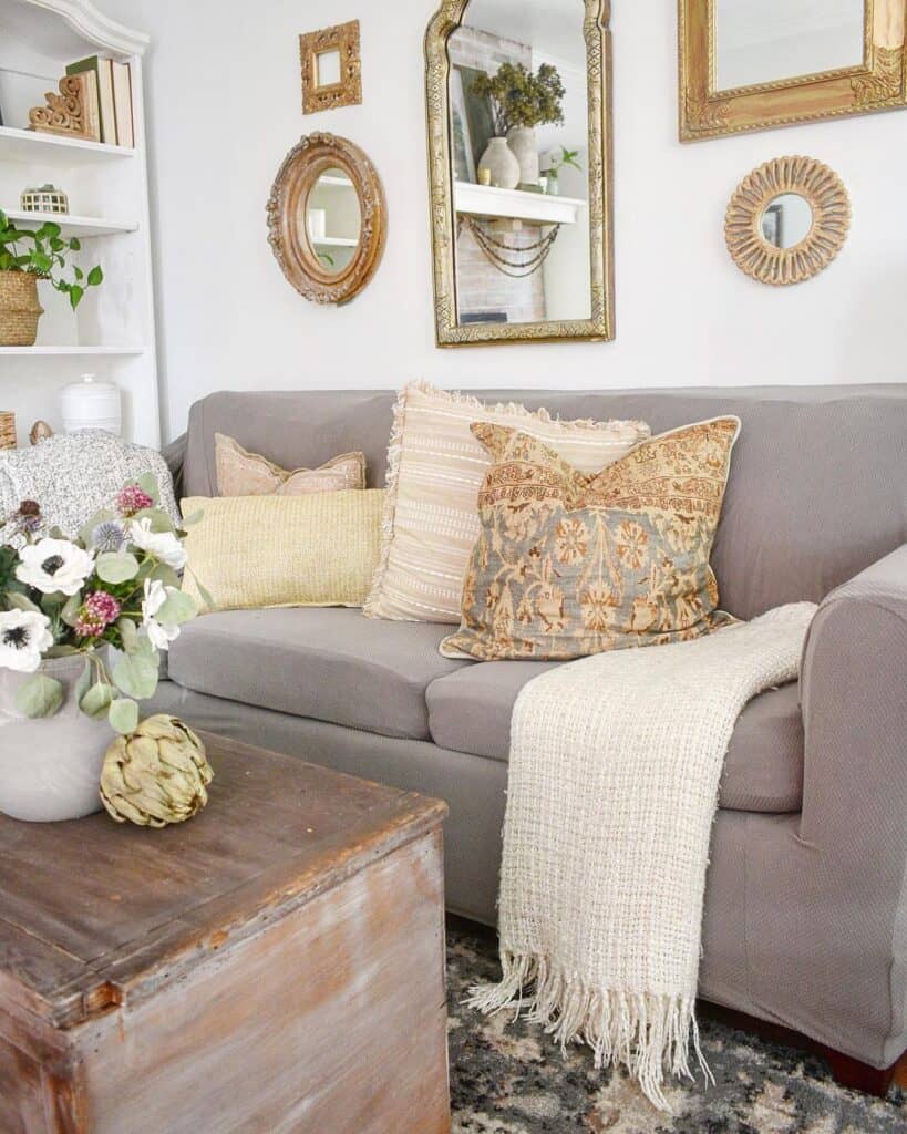 Gold Framed Mirrors Over a Grey Sofa