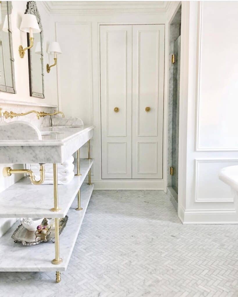 Gold and White Bathroom with Light Grey Herringbone Tile