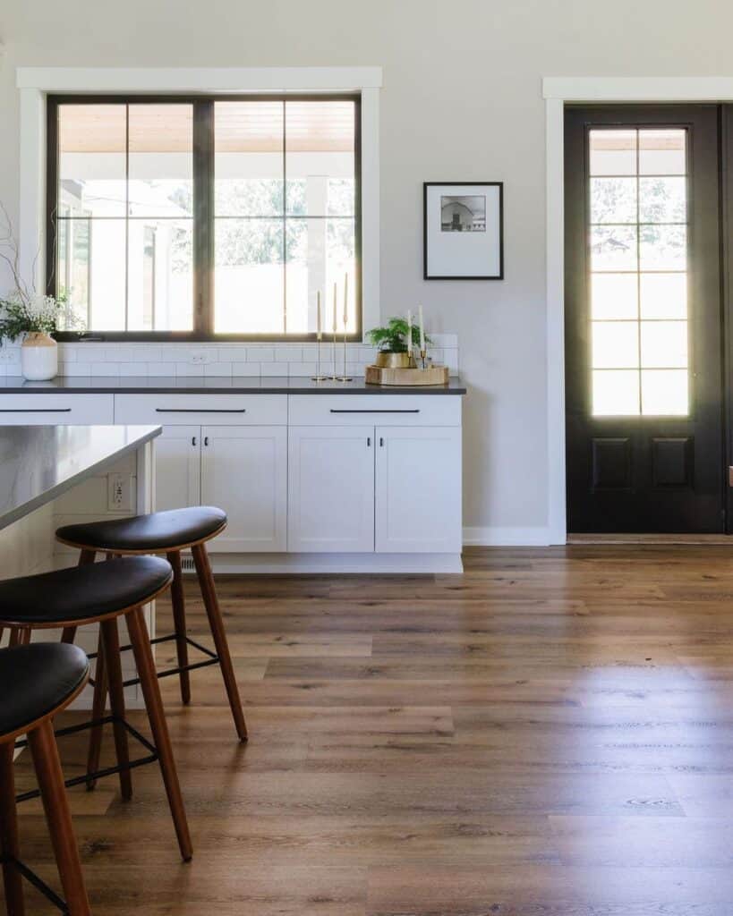 Kitchen With White Baseboard and Deep Wood Floor