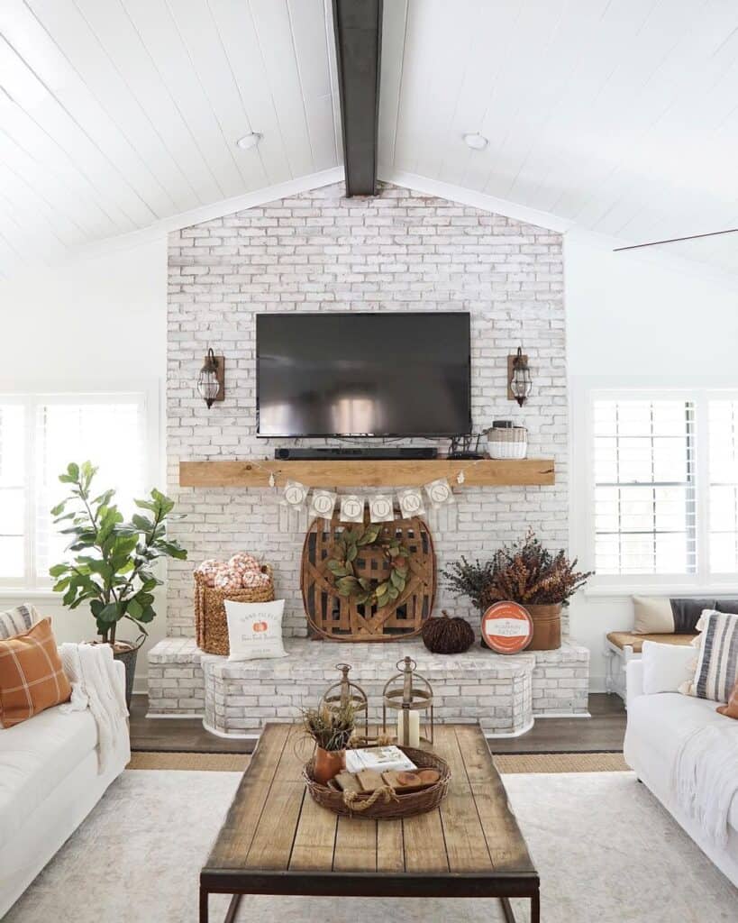 Large White Brick Fireplace with a TV