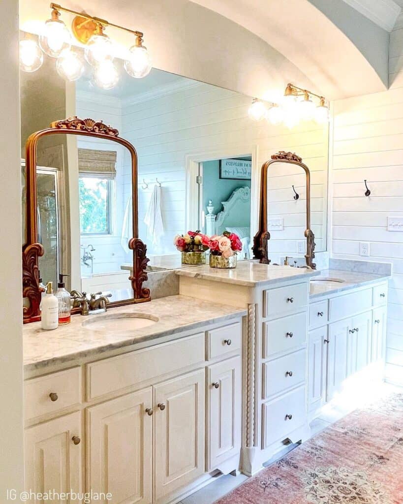 Layered Mirrors Over White Marble Bathroom Countertops