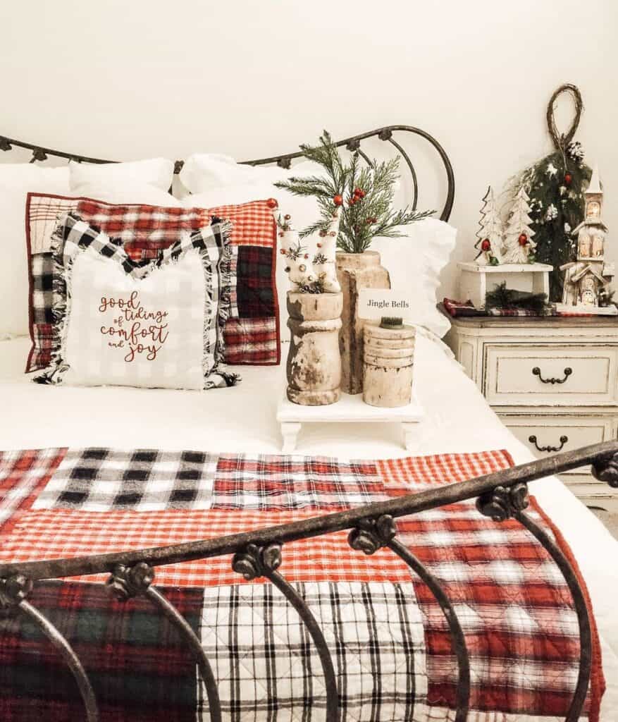 Metal Bed with Red Christmas Quilt
