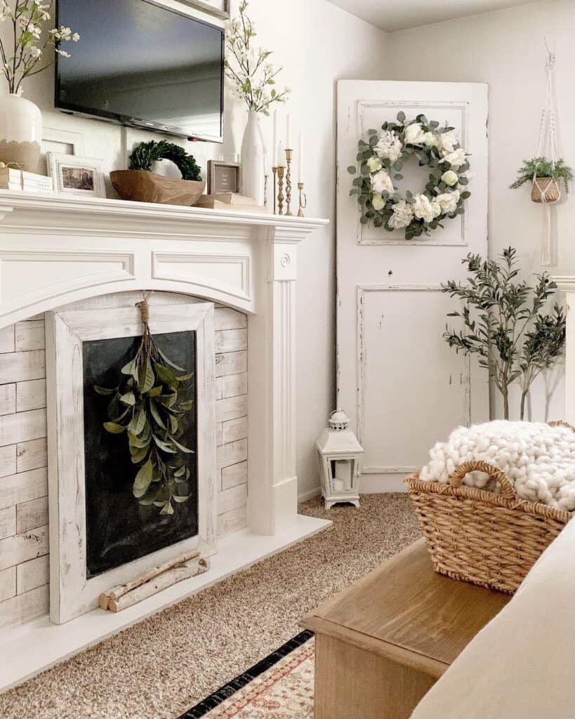 Small TV Hanging Over White Fireplace