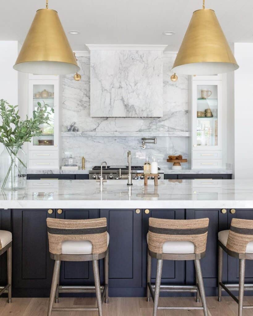 Two Large Gold Lamps Above a Black Kitchen Island