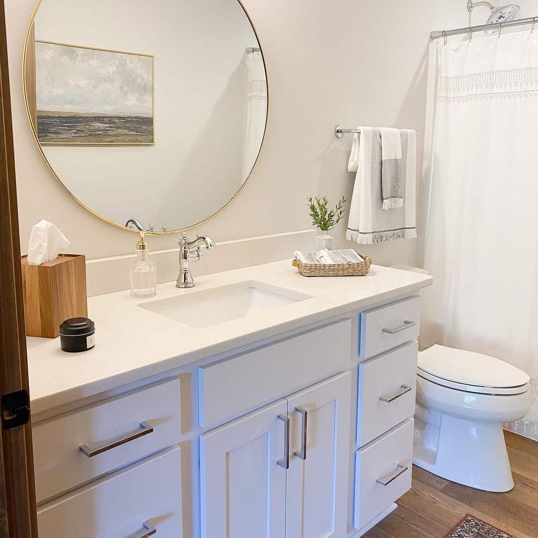 white bathroom cabinets with dark countertops