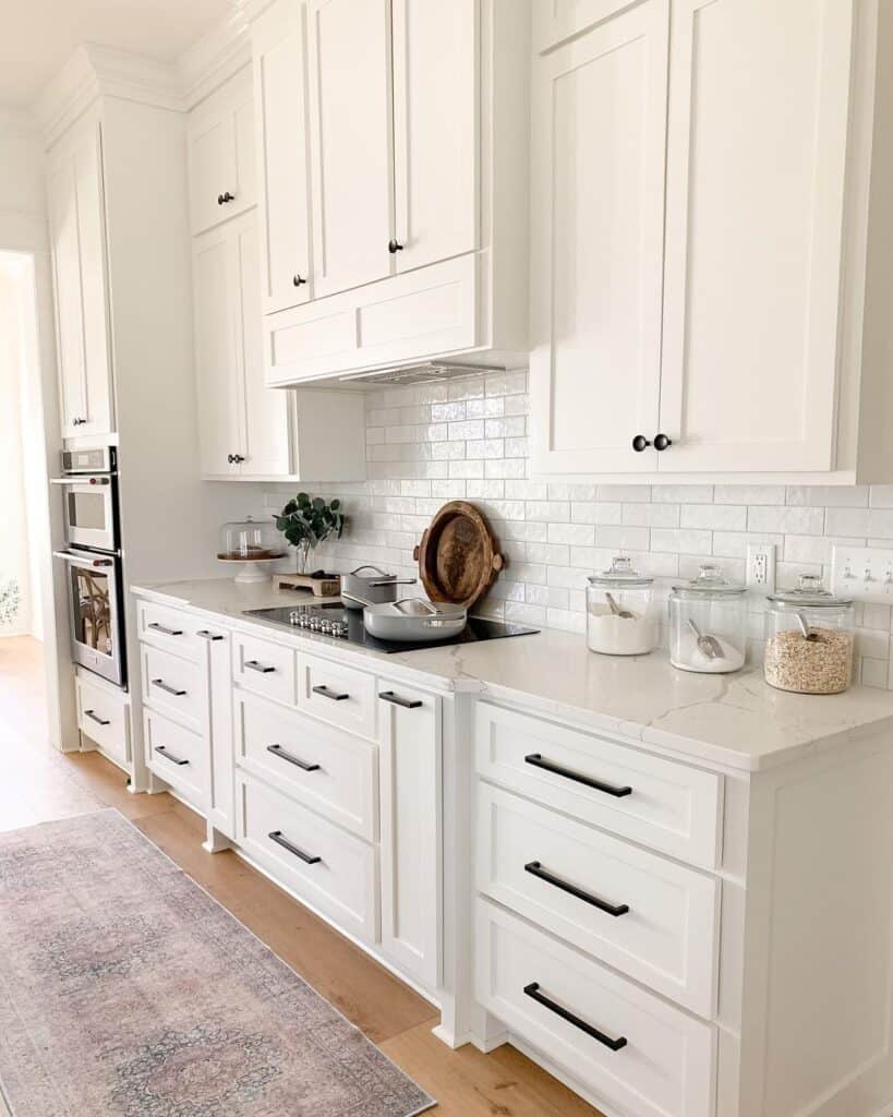 White Kitchen with Black Hardware and Hardwood Floors