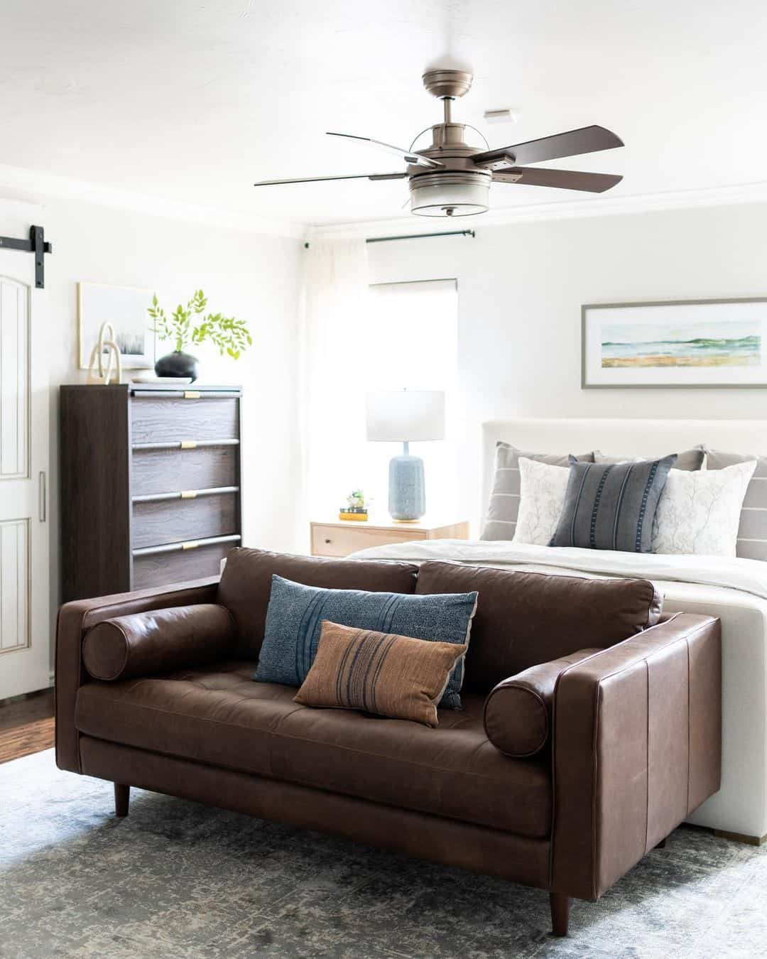 Bedroom with Brown Leather Couch - Soul & Lane