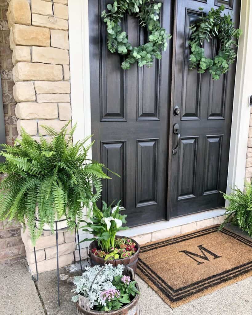 Black Double Front Doors with Green Wreaths