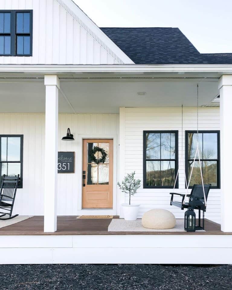 Black Porch Swing and White Siding