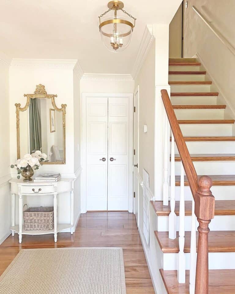 Entryway with Light Hardwood and White Staircase Trim