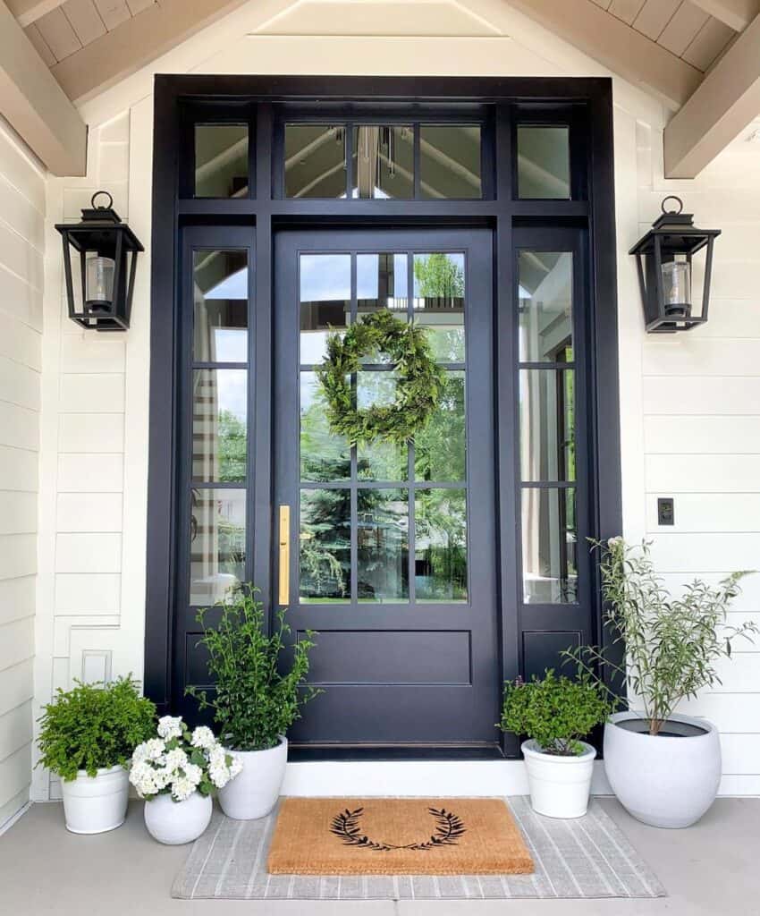 Green Wreath on a Black Front Porch With Sidelights and Transom
