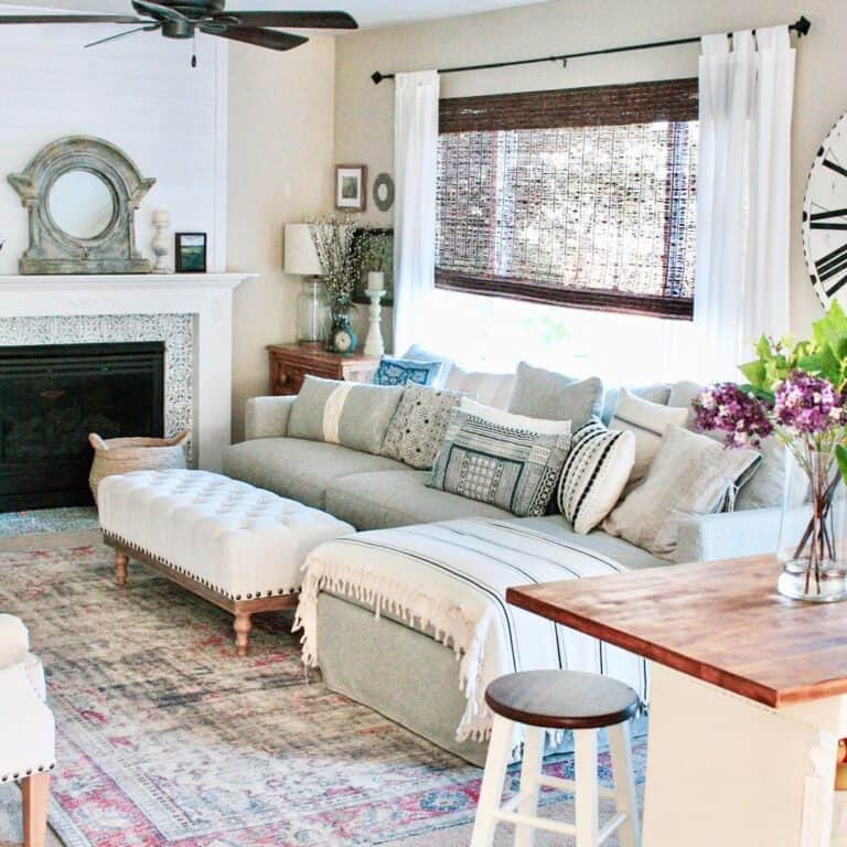 Grey Couch with Pillows and Tufted Ottoman