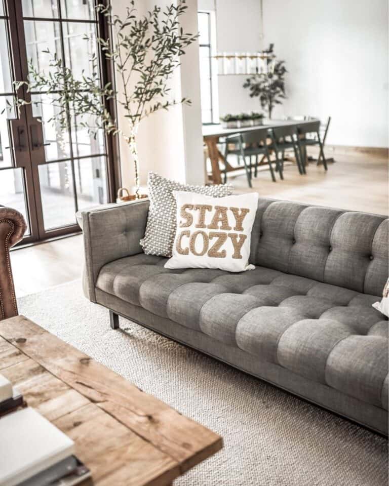 Grey Tufted Couch with White and Grey Throw Pillows
