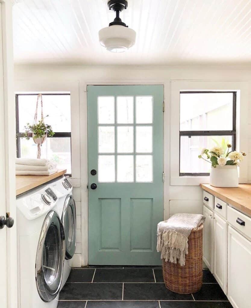 Laundry Room with Black Tile Flooring