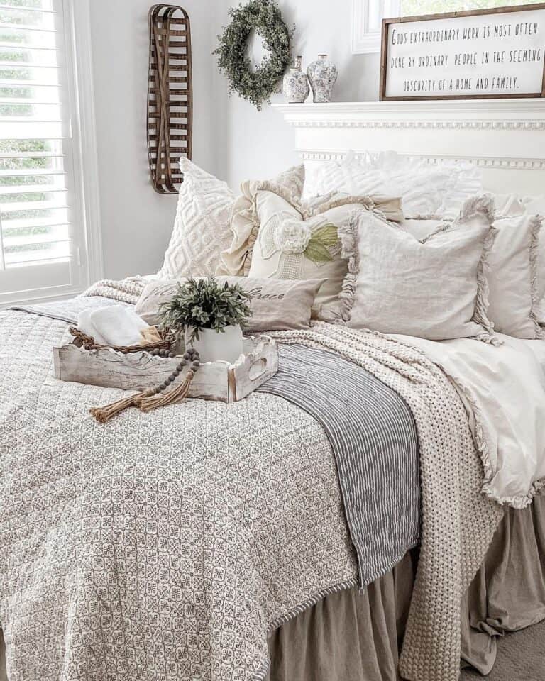 Ornate Bed with Beige and Grey Coverlets