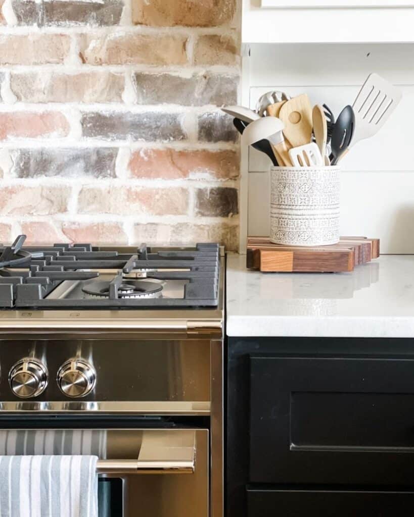 Red Brick Backsplash in Kitchen With White Shiplap Walls