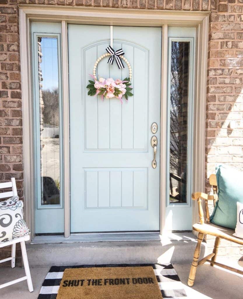 Small Flowering Wreath on Light Blue Front Door with Sidelights